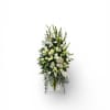 A tall, elongated display of pure white lilies, hydrangeas, and delicate filler