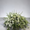 Low, elongated arrangement of white flowers with arching green buds in an all-around spray shape