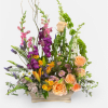 Colorful mixed arrangement of peach roses, yellow lilies, and purple flowers in a wooden box.