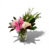 Arrangement of pink roses, pale tulips, and blush hydrangeas in a clear glass vase