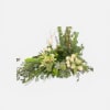A long, low cremation wreath that brings a calm, natural presence to
