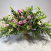 Soft lavender and deep purple blooms mingle with pink roses and lilies