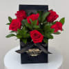 This sleek arrangement highlights classic romance with velvety red roses nestled among