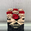 Chic and modern, this preserved arrangement combines deep red roses with metallic