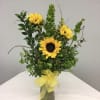 A beautiful bouquet of sunflowers with complimentary greenery and accented with gorgeous