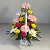 White whicker Basket filled with Carnations, Daisies mini Carnations and fillers