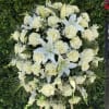 A graceful arrangement of pure white flowers, symbolizing peace, remembrance, and eternal