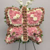 Butterfly-shaped floral standing spray in pink and white