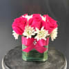 A compact dome of bright pink roses and crisp white chrysanthemums creates