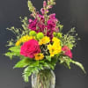 Hot pink roses and tall magenta snapdragons create an energetic vertical silhouette