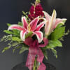 A dramatic stargazer-style lily takes center stage in this red, pink and