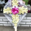 Beautiful Palm Crosses, with a colorful bow and artificial lilies. Local Cemetery