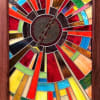 A radiant stained glass wall art piece that reads like a sunburst