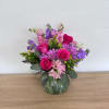 This lush, hand-designed arrangement brings together bold hot pink roses, purple stock