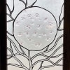 A sculptural frosted glass panel framed in rich light poplar wood makes