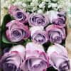 12 long stem lavender roes in a box with greenery elegantly set.