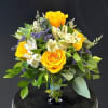 Sunny yellow roses, intense purple alstroemeria, yellow daisies, and purple statice brightens