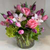 A enchanted design with orchids, roses, tulips, green hydrangeas a mix of