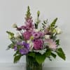 A stunning garden-style floral arrangement designed in soft shades of lavender and