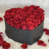 A stunning heart-shaped box filled with premium red roses, finished with a