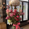 Pink rose bouquet in a glass vase with a birthday balloon and number 12 topper