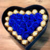 Striking blue roses surrounded by decadent chocolates, beautifully arranged in a keepsake