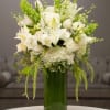 White and Green floral arrangement in a tall vase