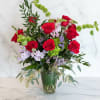 A fresh take on the classic dozen - luxurious red roses designed