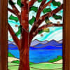 A tranquil stained glass wall art piece that brings a lakeside spring