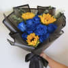 Vivid blue roses paired with sunny yellow sunflowers make a bold, modern