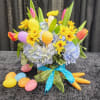 A spring arrangement with hydrangea, assorted tulips and pomps with a hidden