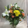 Lily, Roses, Daisy, Cushion mums, Tulips, Carnations, Hypericum, and wax flowers