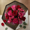 A lush arrangement of roses in varying shades of pink and deep
