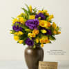 A vibrant mix of yellow tulips and roses paired with rich purple