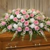 A soft and elegant casket spray designed in a gentle palette of