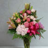 This is a gorgeous flower arrangement in tones of pinks with some