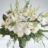 A timeless arrangement of white lilies, roses, snapdragons, and carnations, elegantly styled