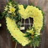 This heartfelt arrangement features vibrant yellow carnations, known for their enduring love