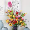 Brighten any room with our signature Spring Bloom arrangement- A vibrant celebration