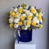 A radiant mix of yellow and white roses with purple accents, elegantly