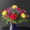 A fun and bright arrangement with carnations, alstroemeria, and monte casino.