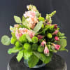 Soft pink stock takes center stage in this low, compact flower arrangement