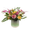 This joyful bouquet dances with soft pink dahlias, sunny yellow roses, and