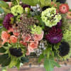 Sun flowers, spray roses, brunia,  dahlia, straw flower, hellebores in a