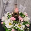 A tall glass bottle of ros&eacute; rises from the center of a