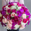 Round bouquet of pink roses, white hydrangeas, and purple orchids