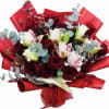 &ldquo;A stunning bouquet featuring passionate red roses paired with elegant lilies. This