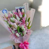 Soft pale pink and creamy white tulips gathered with tiny pink filler