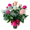 A dozen mixed roses arranged beautifully in a vase with greens and