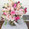 Gardenroses in pretty powder pastels accompanied by stock, geranium &amp; vax flowers.